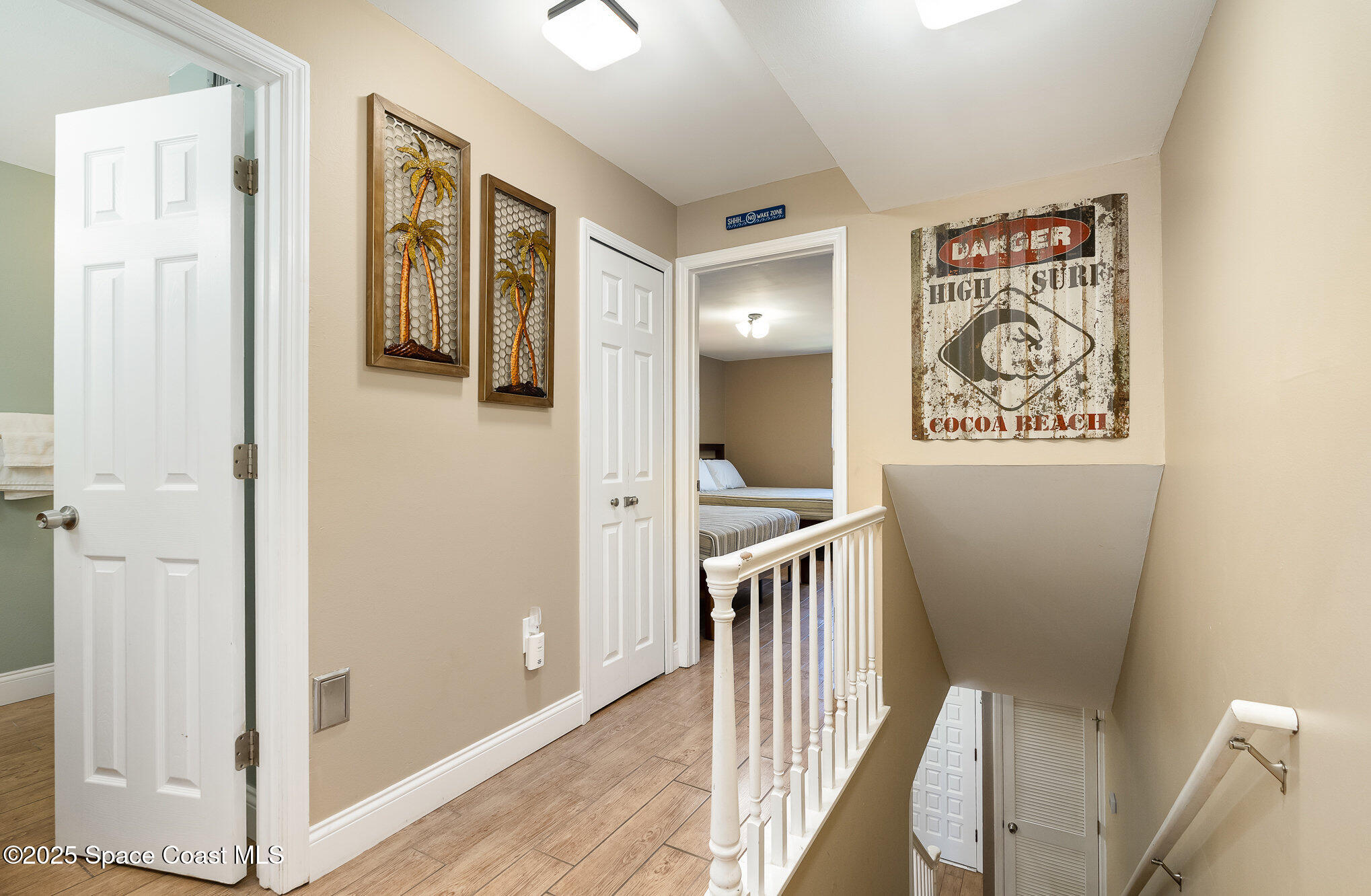 5350 Ocean Beach Boulevard, Unit 211 Cocoa Beach, FL 32931 - Photo 23 of 37 a view of a hallway with a hallway and wooden floor