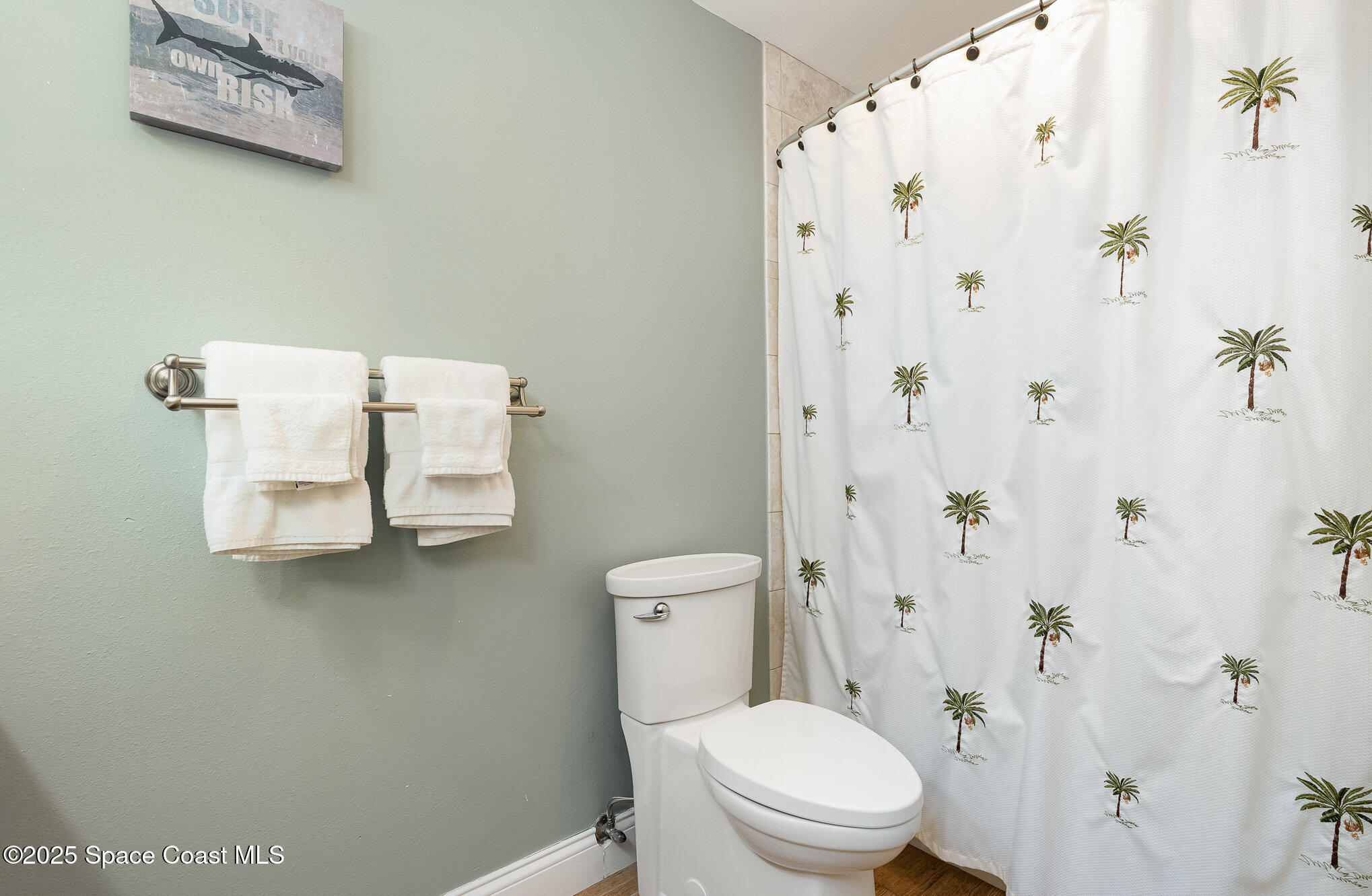 5350 Ocean Beach Boulevard, Unit 211 Cocoa Beach, FL 32931 - Photo 25 of 37 a white toilet sitting next to a bathroom sink