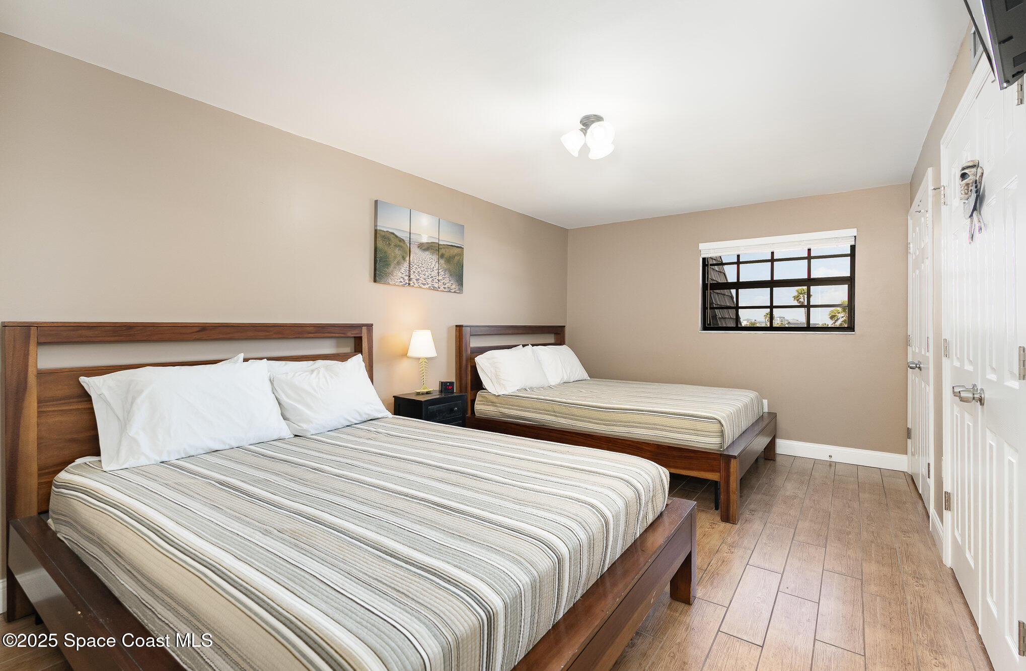 5350 Ocean Beach Boulevard, Unit 211 Cocoa Beach, FL 32931 - Photo 26 of 37 a bedroom with double bed and a window