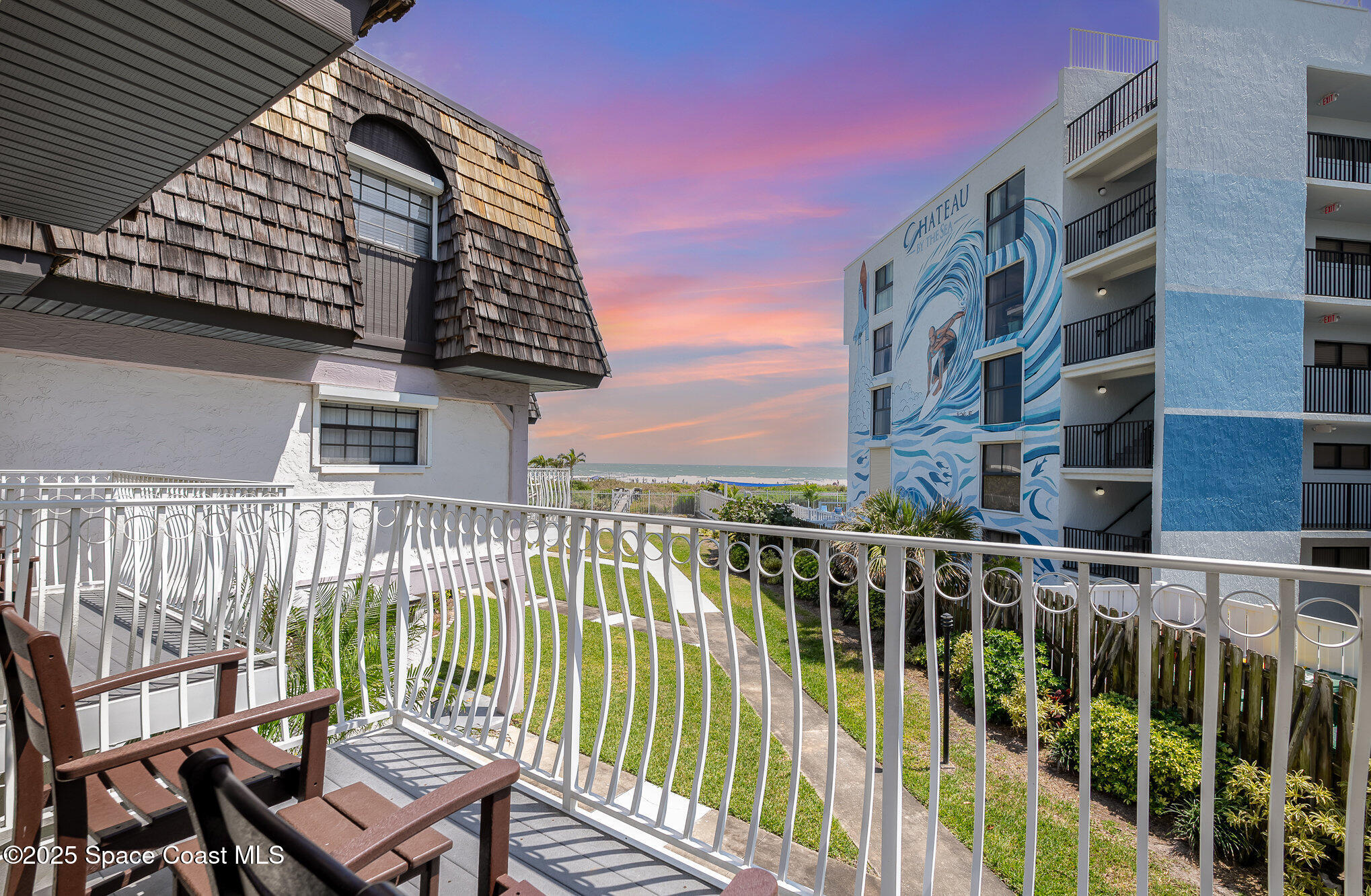 5350 Ocean Beach Boulevard, Unit 211 Cocoa Beach, FL 32931 - Photo 33 of 37 a view of a balcony with wooden floor and fence