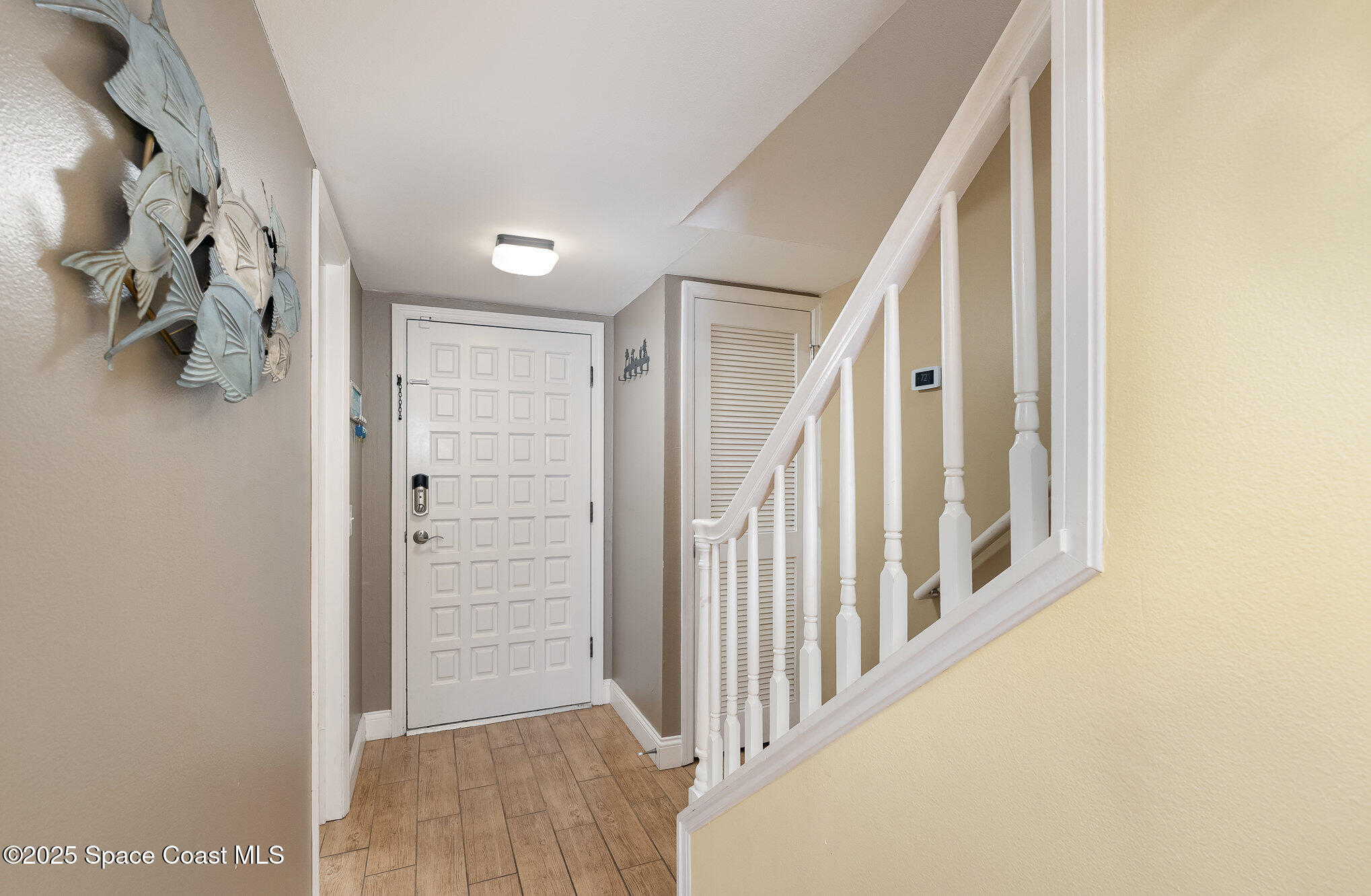 5350 Ocean Beach Boulevard, Unit 211 Cocoa Beach, FL 32931 - Photo 34 of 37 a view of a hallway with wooden floor and entryway