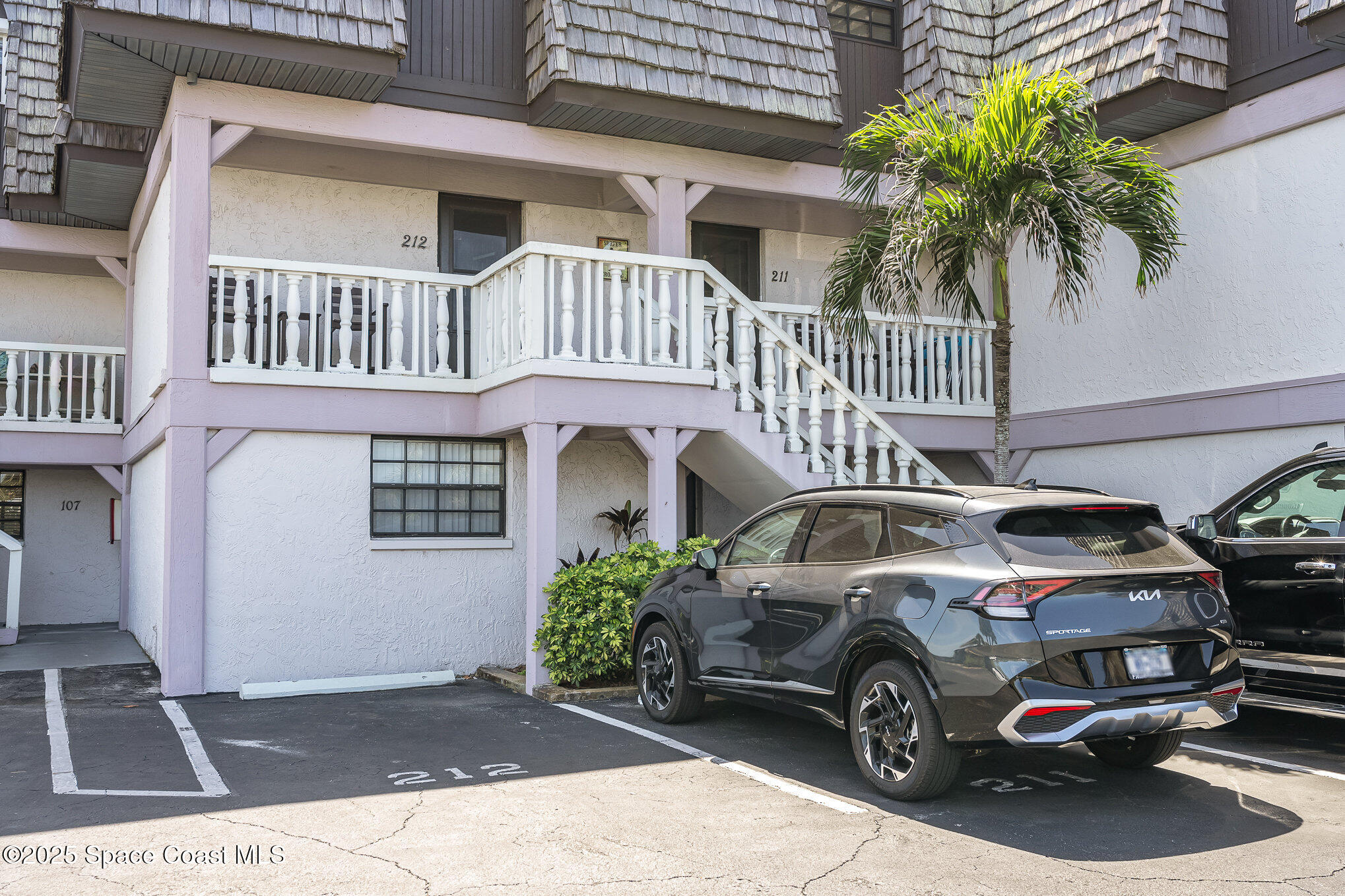 5350 Ocean Beach Boulevard, Unit 211 Cocoa Beach, FL 32931 - Photo 35 of 37 a view of a car parked in front of a house