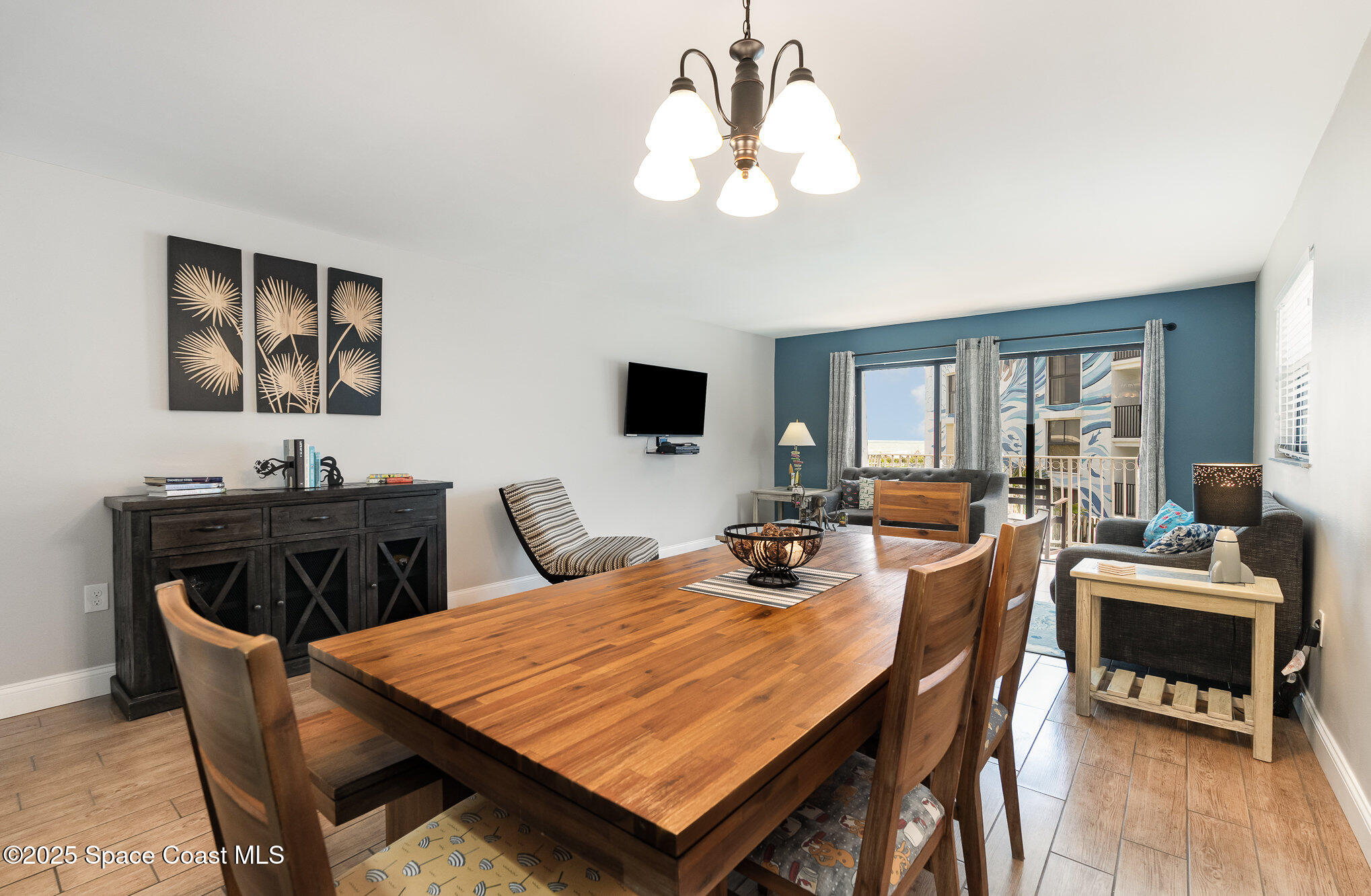 5350 Ocean Beach Boulevard, Unit 211 Cocoa Beach, FL 32931 - Photo 7 of 37 a view of a dining room with furniture and wooden floor