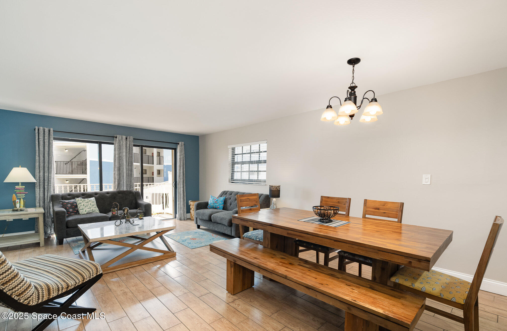 5350 Ocean Beach Boulevard, Unit 211 Cocoa Beach, FL 32931 - Photo 10 of 37 a living room with furniture and wooden floor