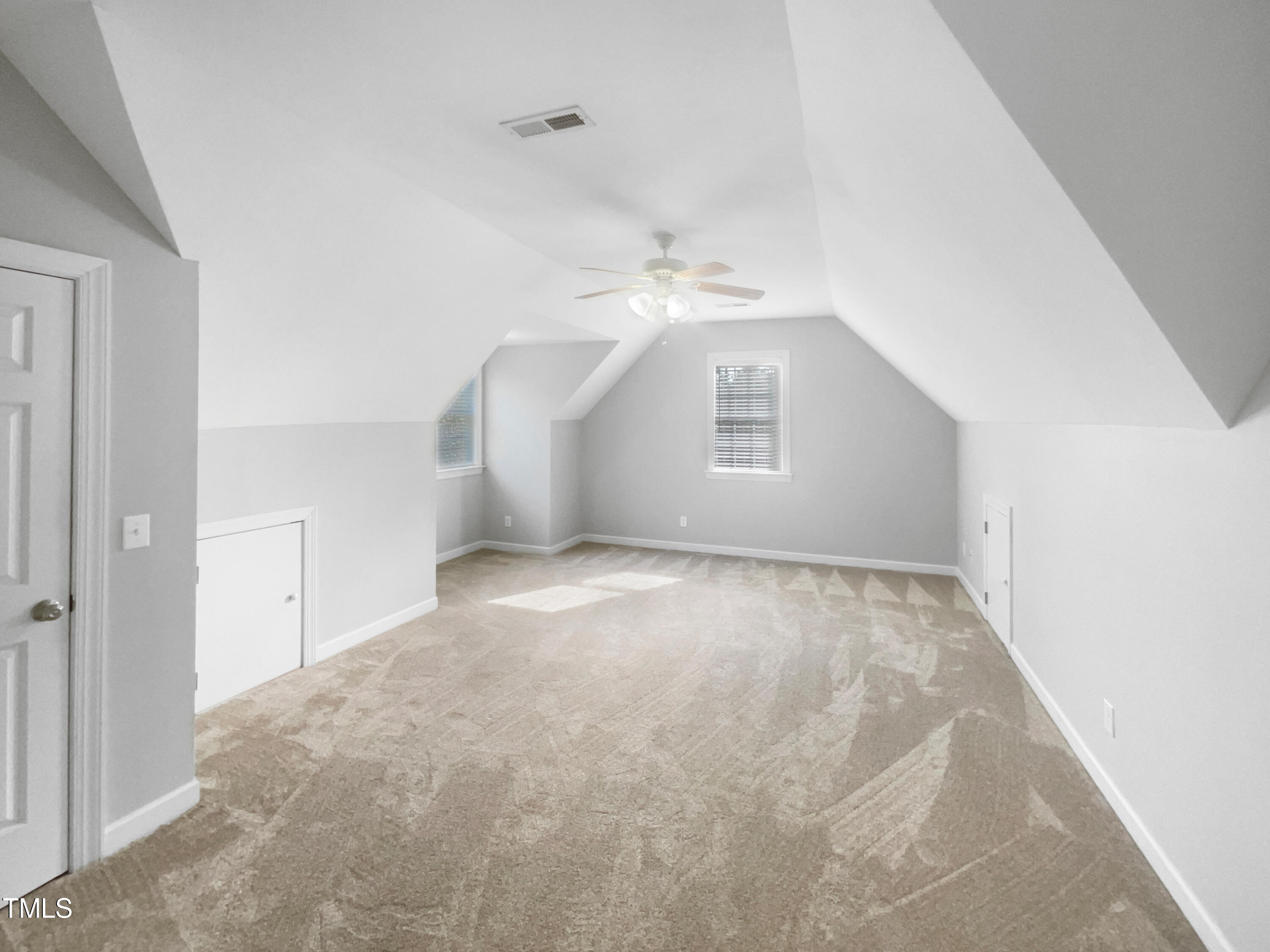 90 Carrousel Court Angier, NC 27501 - Photo 15 of 31 an empty room with windows and chandelier fan