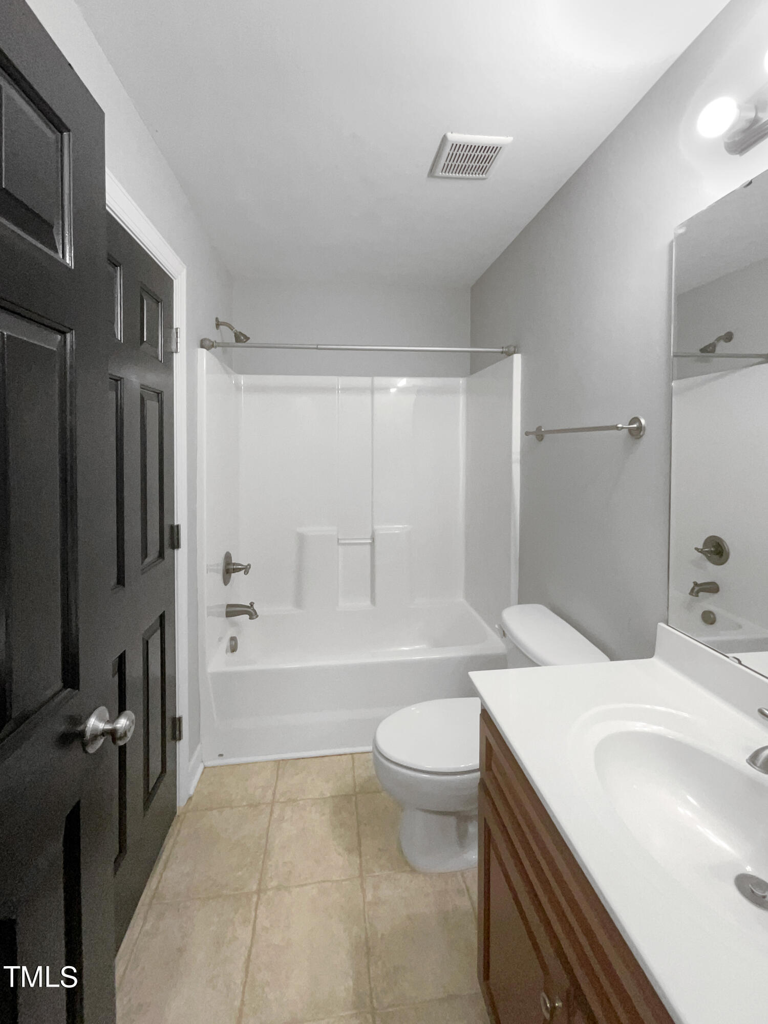 90 Carrousel Court Angier, NC 27501 - Photo 16 of 31 a bathroom with a sink a toilet a mirror and bathtub