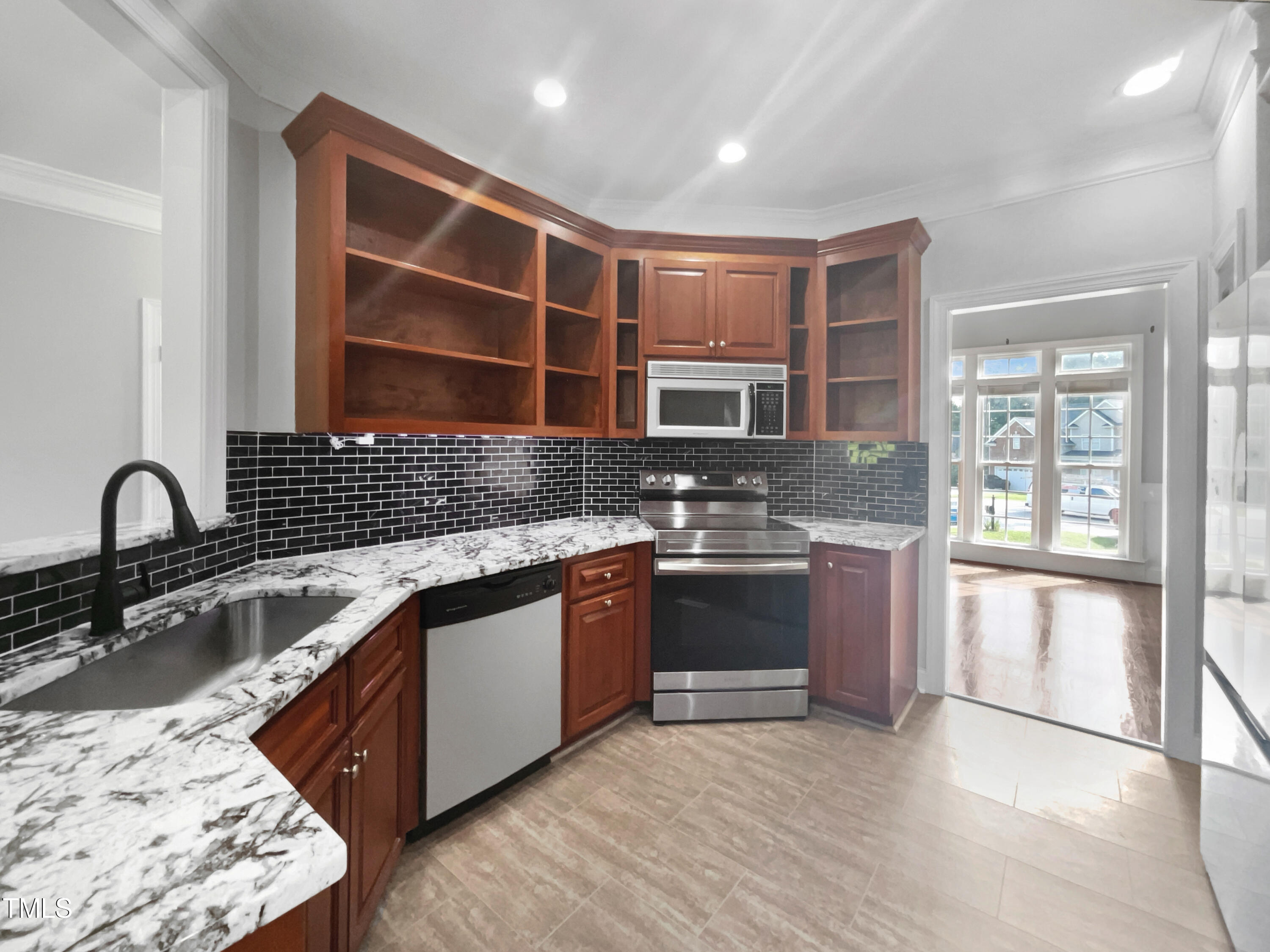 90 Carrousel Court Angier, NC 27501 - Photo 22 of 31 a kitchen with stainless steel appliances granite countertop a sink stove and cabinets