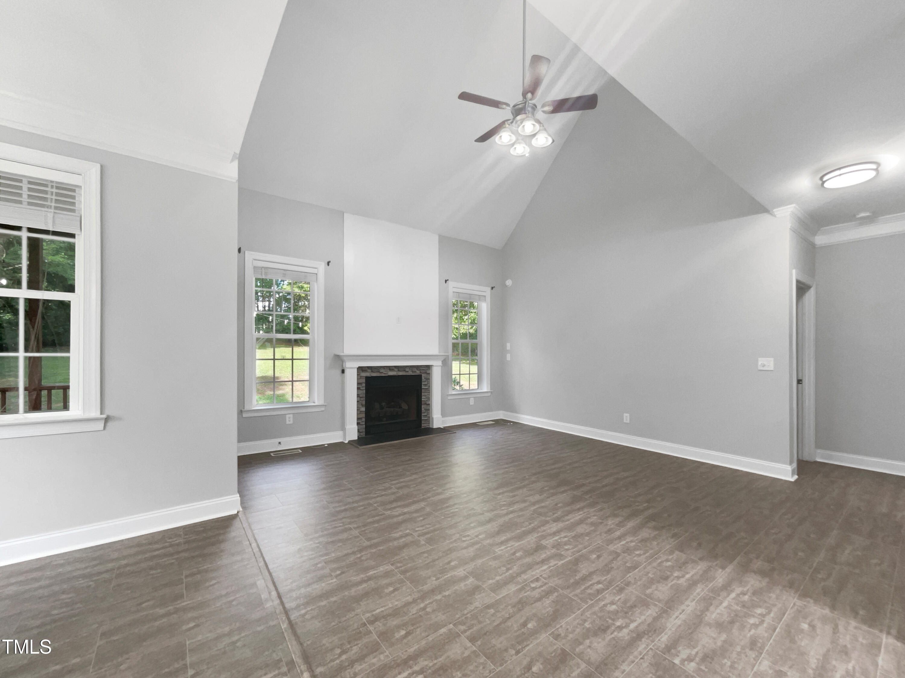 90 Carrousel Court Angier, NC 27501 - Photo 23 of 31 an empty room with wooden floor fireplace and windows