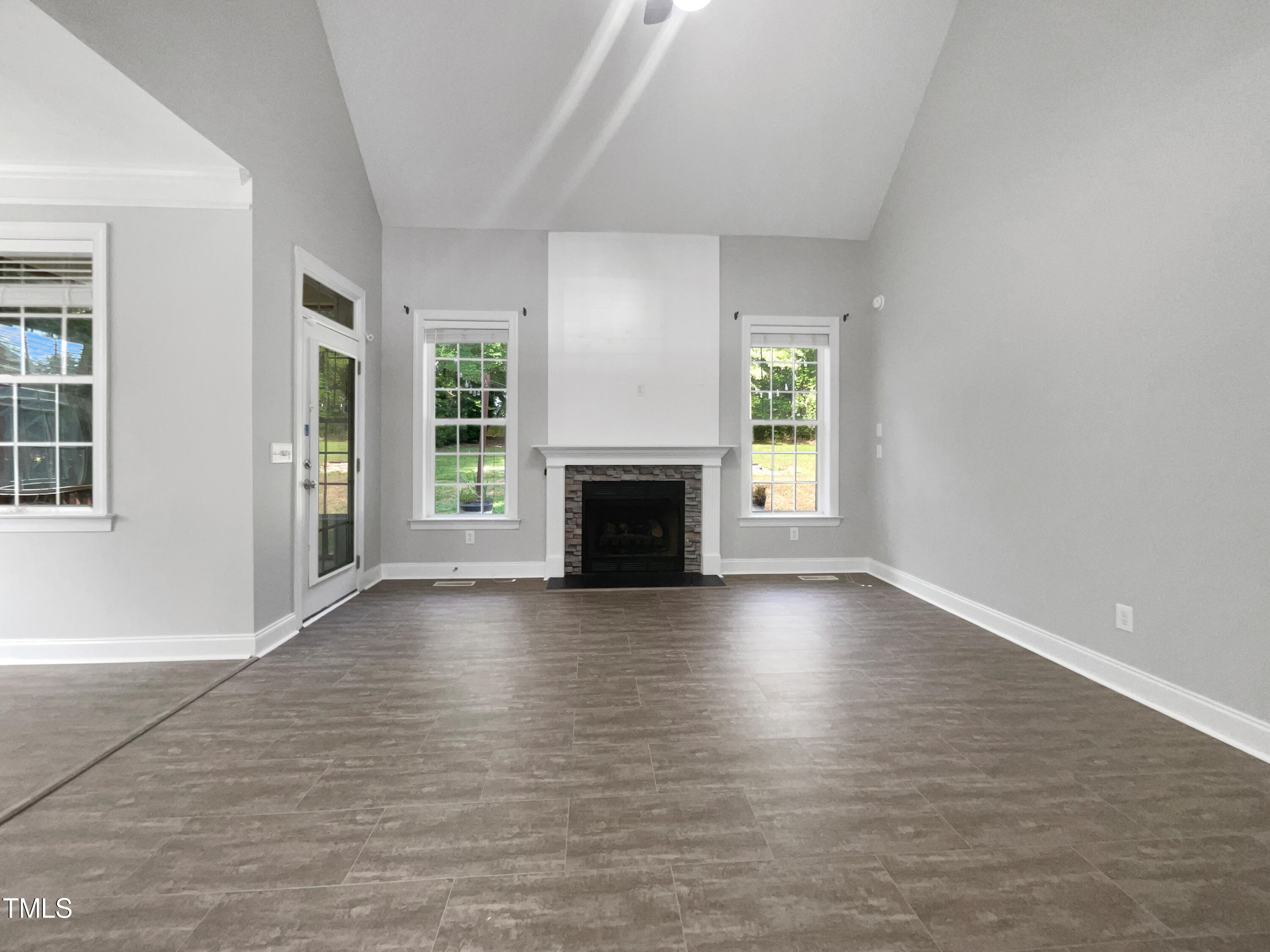90 Carrousel Court Angier, NC 27501 - Photo 25 of 31 an empty room with windows fireplace and windows
