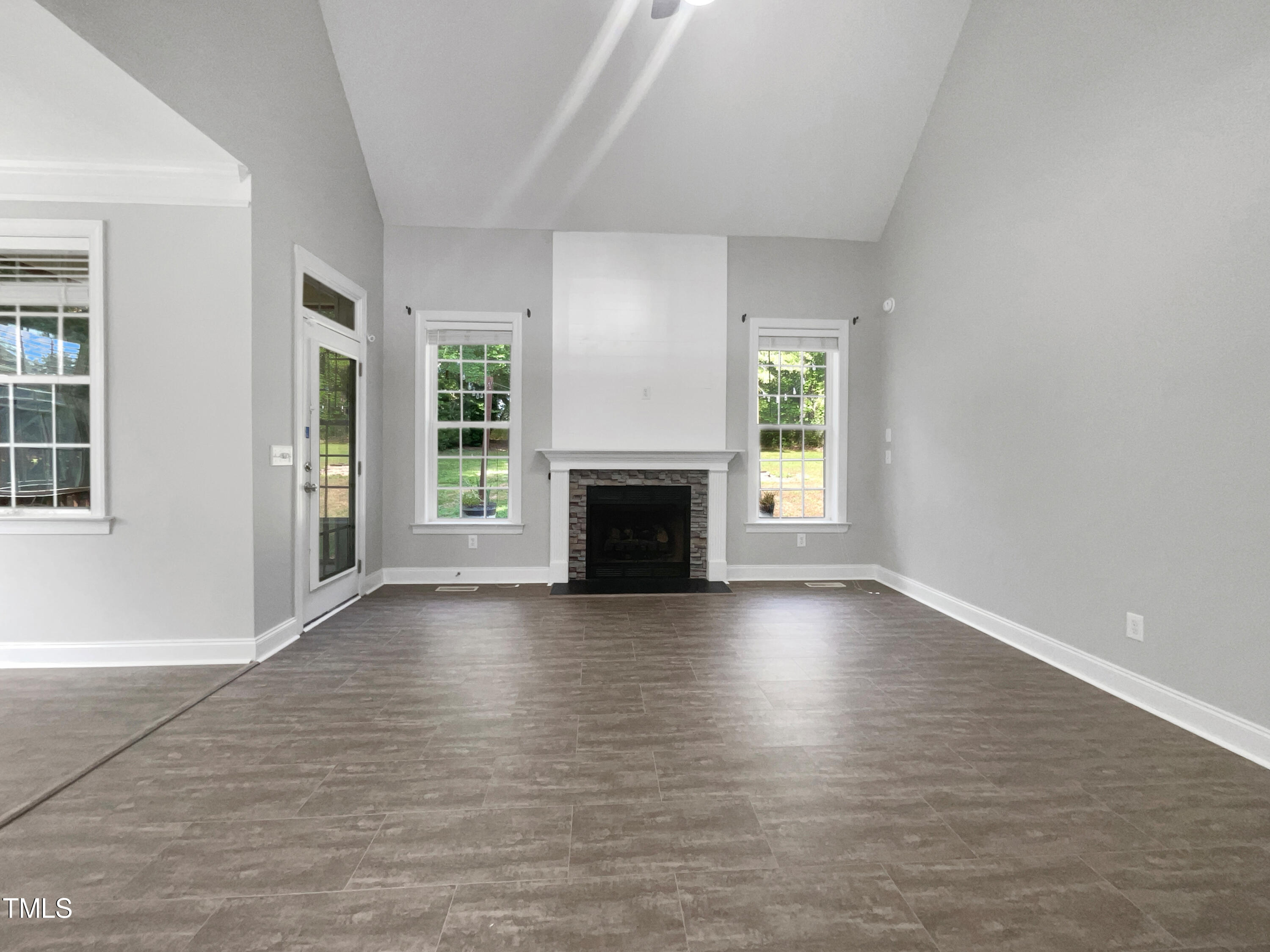90 Carrousel Court Angier, NC 27501 - Photo 3 of 31 an empty room with wooden floor and fireplace