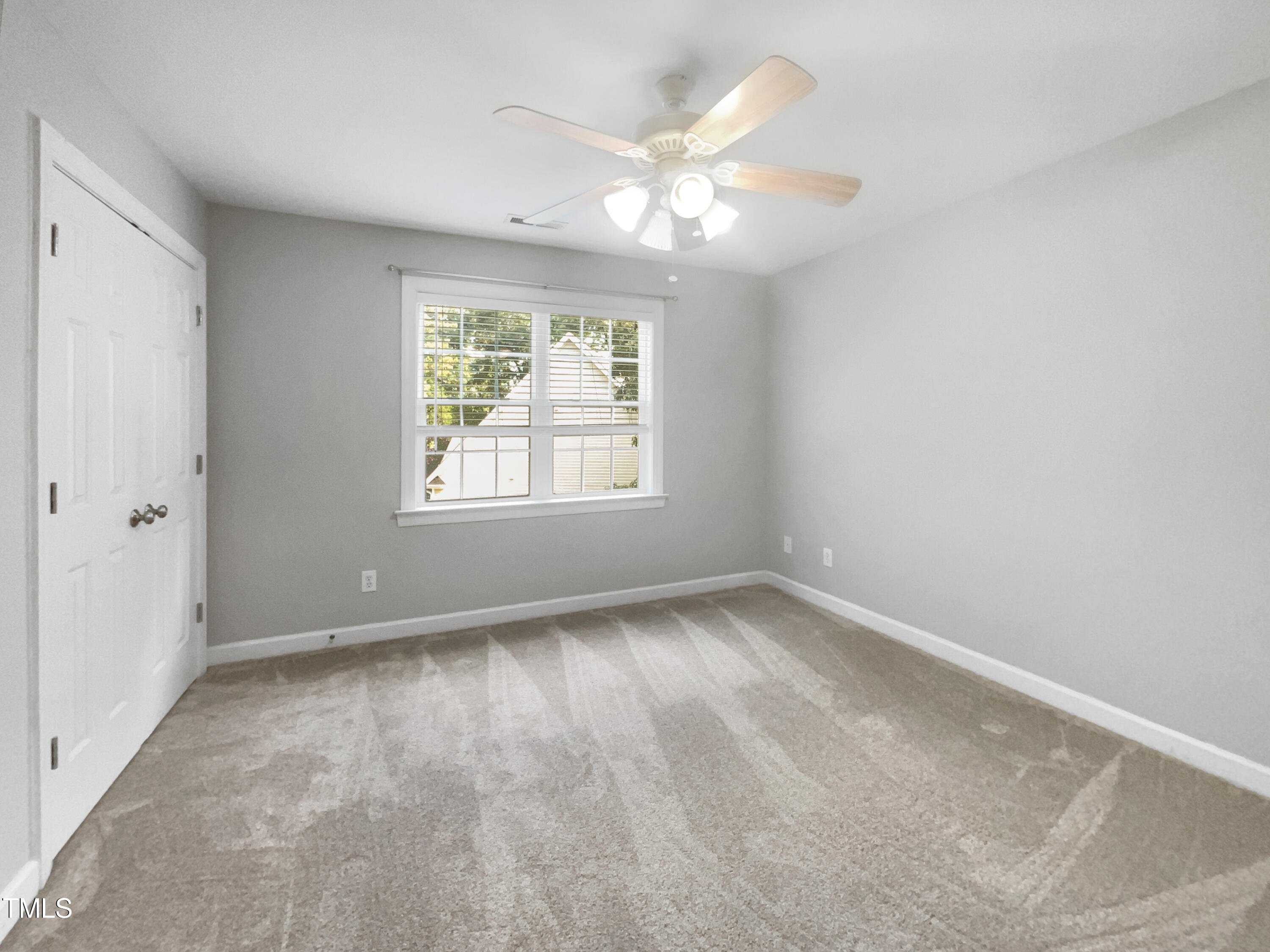 90 Carrousel Court Angier, NC 27501 - Photo 5 of 31 an empty room with windows and chandelier fan