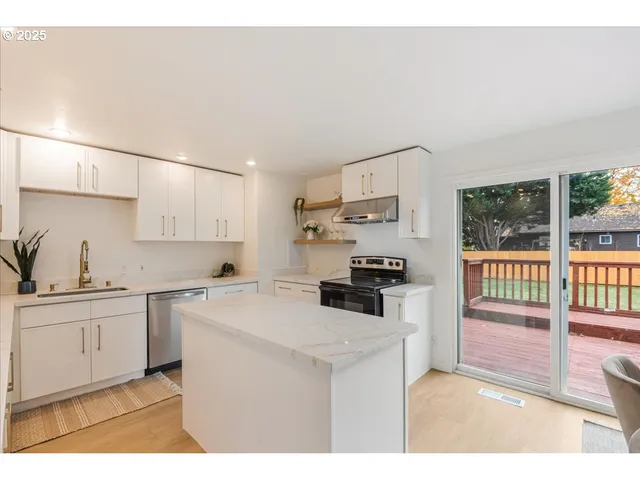 a kitchen that has a sink and a stove