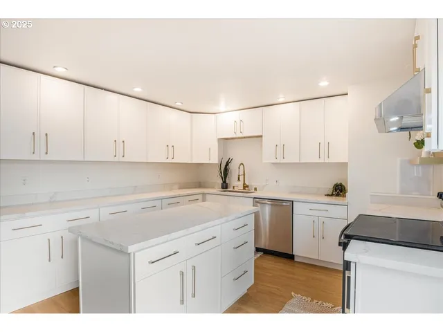 a kitchen with a sink a stove and cabinets