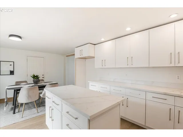 a kitchen with a sink cabinets and wooden floor
