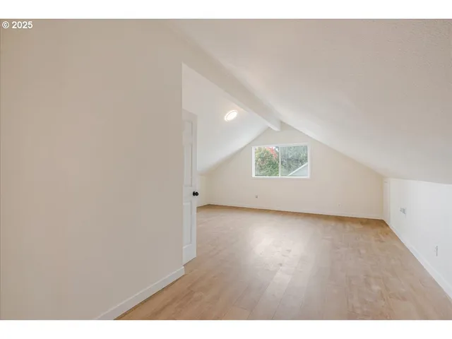 a view of a room with wooden floor and window