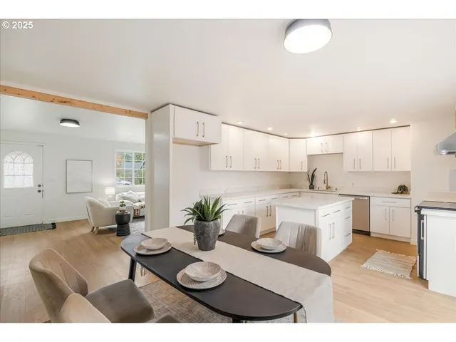 a open kitchen with stainless steel appliances kitchen island granite countertop a sink and white cabinets
