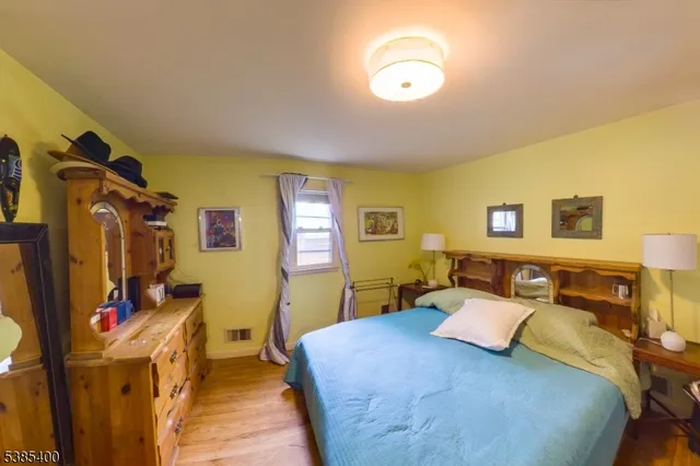 a bedroom with a bed and a couch