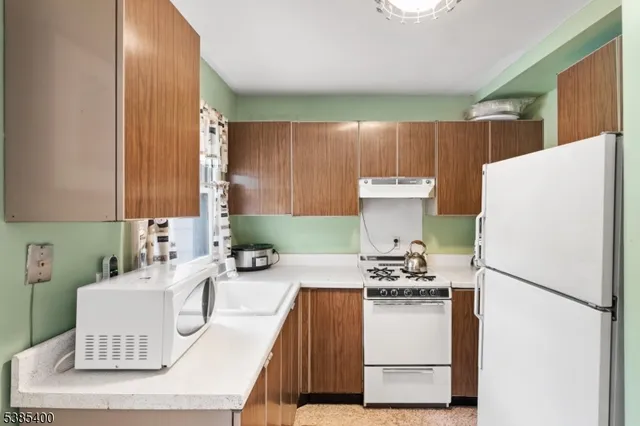 a kitchen with a refrigerator a sink and a stove