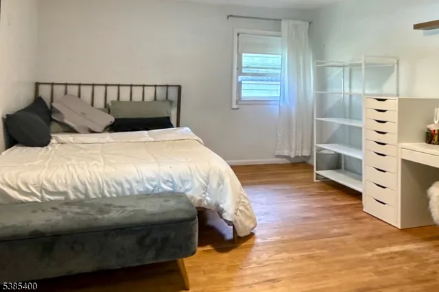 a bed sitting in a bedroom next to a window