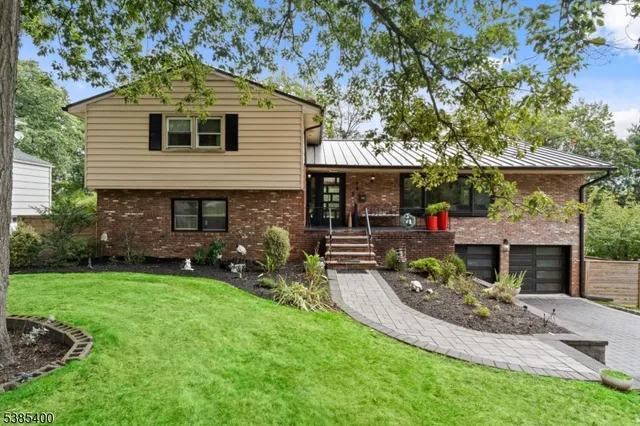 a front view of house with yard and green space