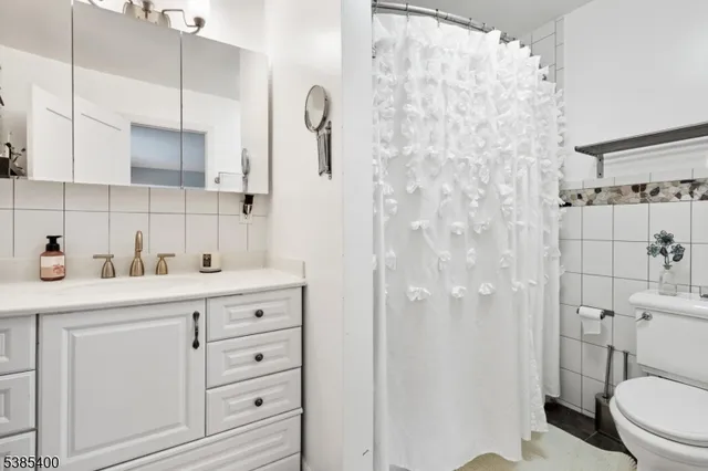 a bathroom with a shower a sink a toilet and a shower