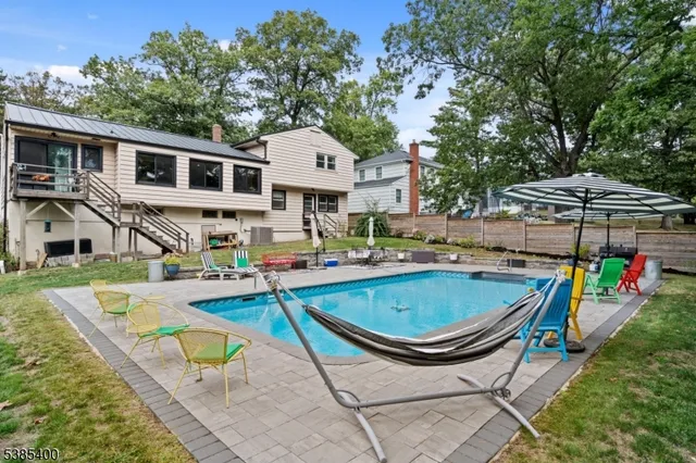 a swimming pool with outdoor seating and yard