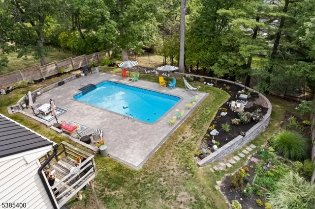 a view of a pool with chairs in patio