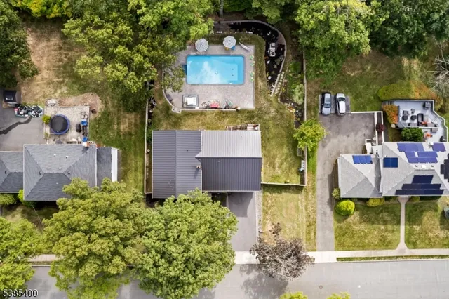an aerial view of a house with a yard basket ball court and outdoor seating