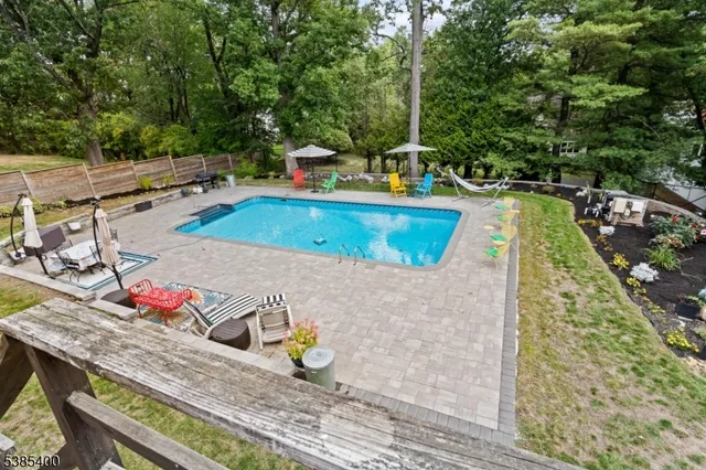 a view of a swimming pool with lounge chairs