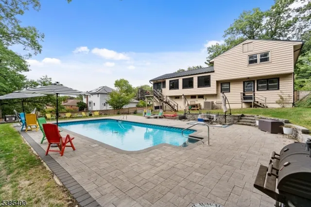 a view of a swimming pool with lounge chairs