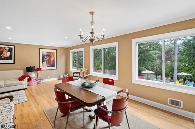 a living room with furniture and large windows