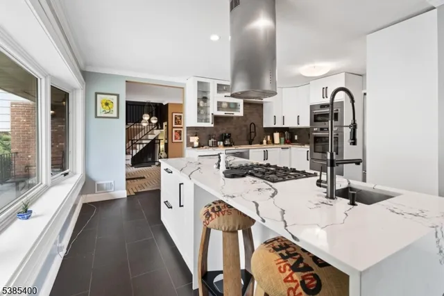 a kitchen with a sink stove and cabinets