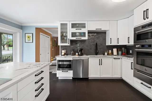 a kitchen with cabinets appliances and a window