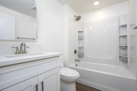 a kitchen with a refrigerator sink and wooden floor