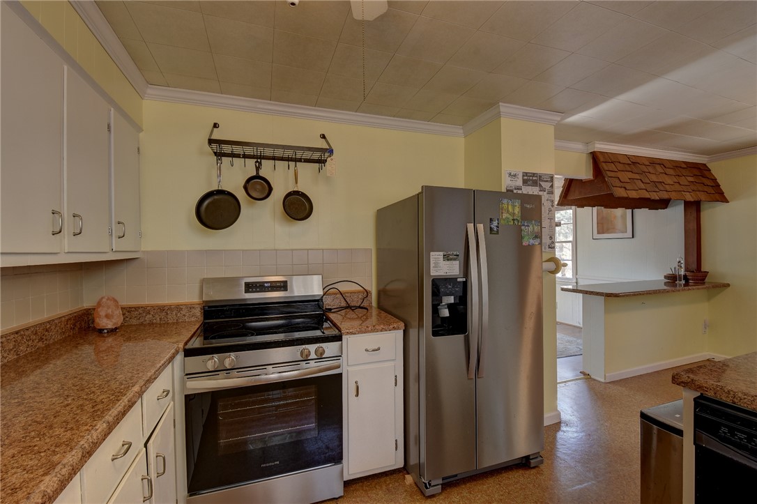 319 Cove Creek Road Pickens, SC 29671 - Photo 12 of 20 This spacious kitchen offers ample countertop space, modern appliances, and convenient open shelving.