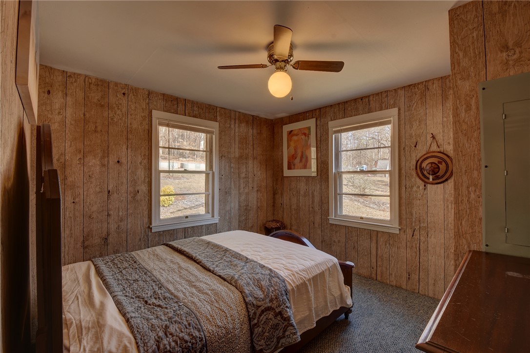 319 Cove Creek Road Pickens, SC 29671 - Photo 15 of 20 This cozy bedroom features rustic paneled walls and large windows for ample natural light.