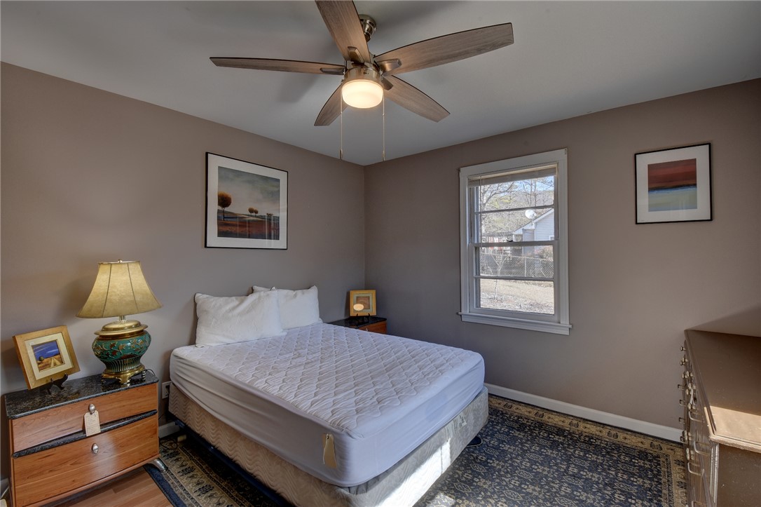 319 Cove Creek Road Pickens, SC 29671 - Photo 18 of 22 This cozy bedroom features a window overlooking the backyard and a ceiling fan for comfort.