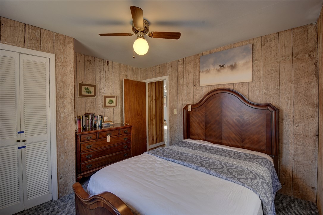 319 Cove Creek Road Pickens, SC 29671 - Photo 21 of 22 This cozy bedroom features rustic wood paneling, offering a warm and inviting atmosphere.