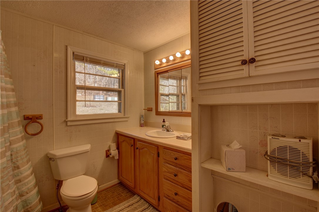 319 Cove Creek Road Pickens, SC 29671 - Photo 22 of 22 This functional bathroom features a single vanity, window, and ample storage solutions.