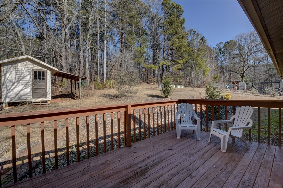 319 Cove Creek Road Pickens, SC 29671 - Photo 6 of 22 This spacious wooden deck offers serene views of the expansive yard and natural surroundings.