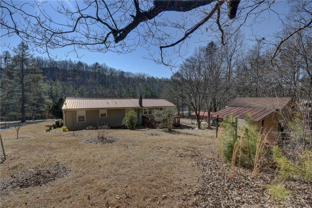 319 Cove Creek Road Pickens, SC 29671 - Photo 7 of 22 This charming home features a durable metal roof, surrounded by a peaceful, natural landscape.