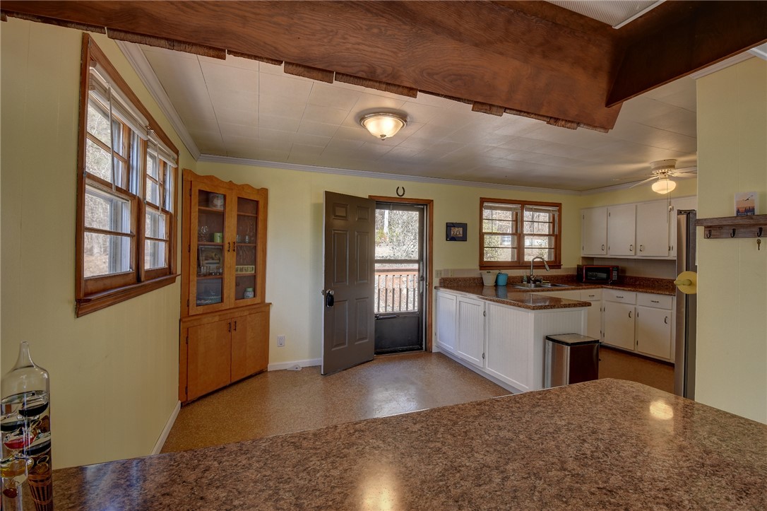 319 Cove Creek Road Pickens, SC 29671 - Photo 10 of 20 This cozy kitchen features a practical layout with warm wood accents and abundant natural light.