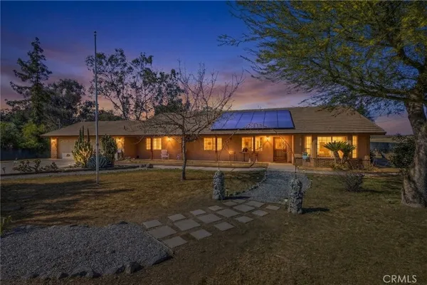 a view of a house with swimming pool and sitting area