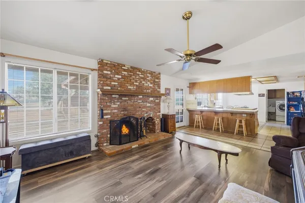 a dining hall with stainless steel appliances a table and chairs in it