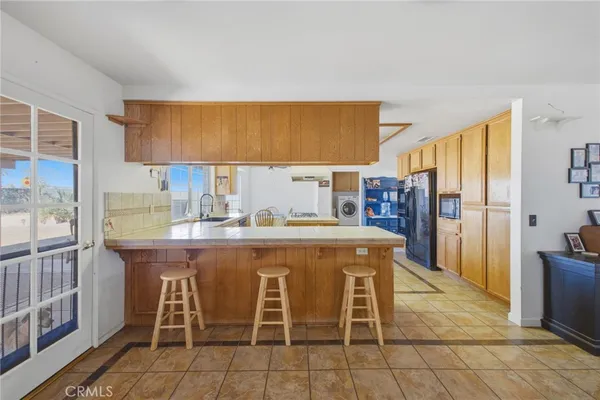 a kitchen with stainless steel appliances granite countertop a stove and a sink