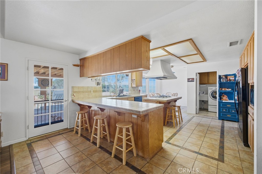 19992 Covell Street Riverside, CA 92508 - Photo 17 of 57 a kitchen with stainless steel appliances granite countertop a stove and a sink