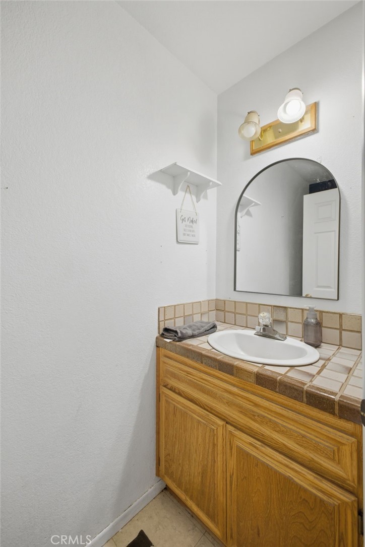 19992 Covell Street Riverside, CA 92508 - Photo 24 of 57 a bathroom with a sink and a mirror