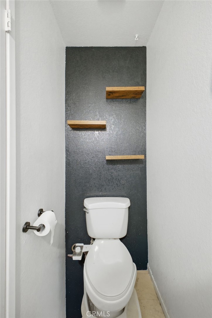 19992 Covell Street Riverside, CA 92508 - Photo 25 of 57 a white toilet sitting next to a shower