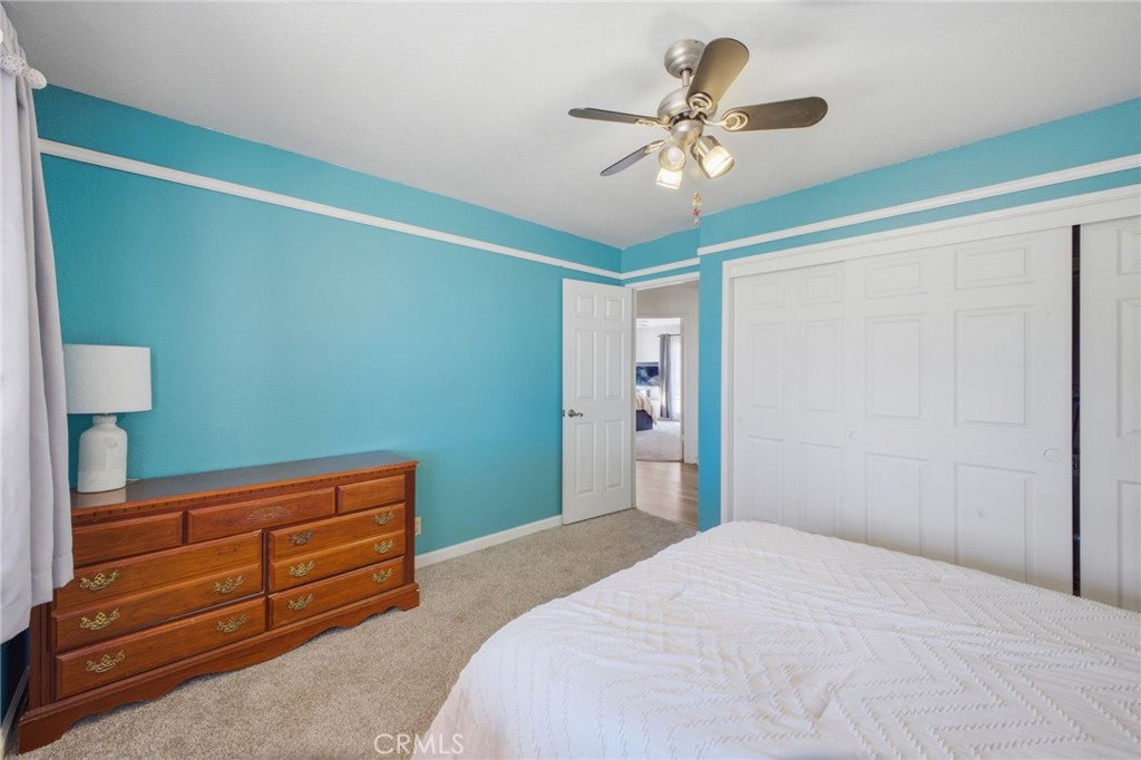 19992 Covell Street Riverside, CA 92508 - Photo 27 of 57 a bedroom with a bed and a chandelier