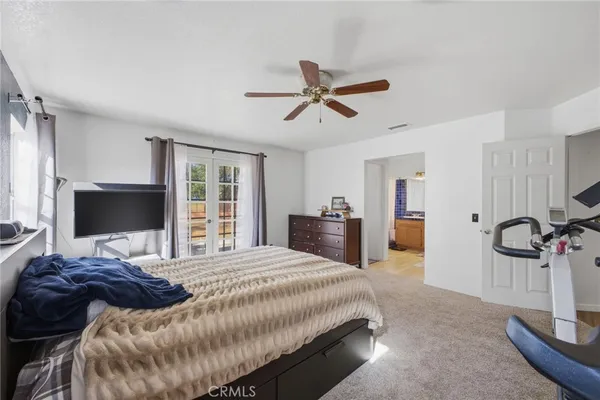 a bedroom with a bed and a mirror
